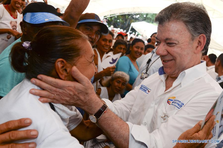 La imagen proporcionada por la presidencia colombiana muestra al presidente colombiano Juan Manuel Santos dando bienvenida a una mujer durante un evento en la localidad de Oveja, Sucre,Colombia el 27 de julio. 