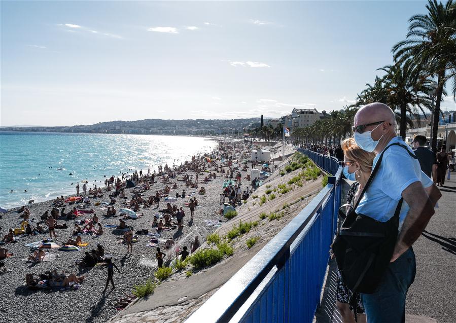 Personas portan mascarillas en Niza, Francia