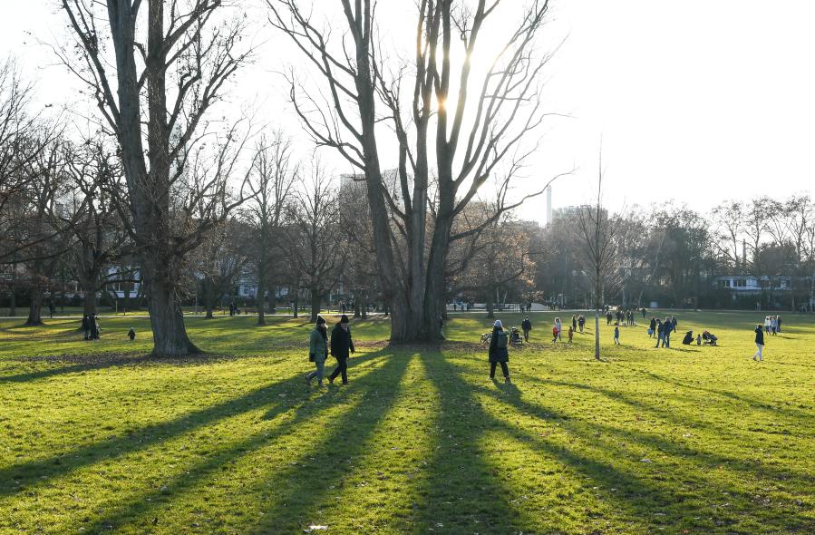Personas disfrutan del brillo solar en un parque en Frankfurt, Alemania